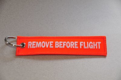 REMOVE BEFORE FLIGHT keychain keyring (orange + white letters)