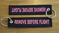 REMOVE BEFORE FLIGHT keychain keyring (black + pink letters)